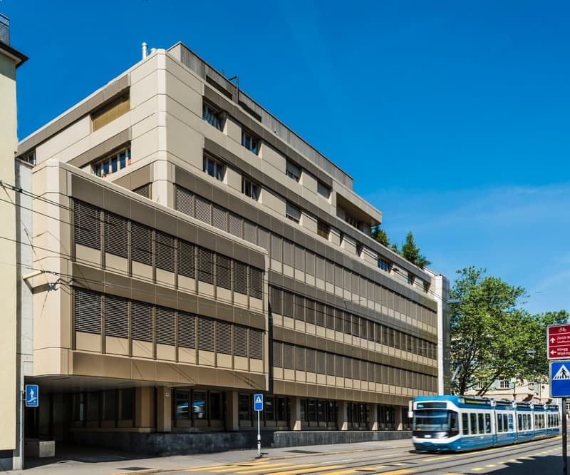 Building has 4 floors, concrete construction, glass windows, large windows