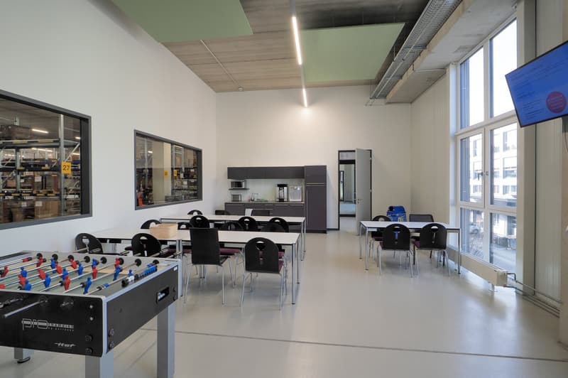 empty meeting room, rectangular tables, chairs, foosball table, microwave, refrigerator, TV