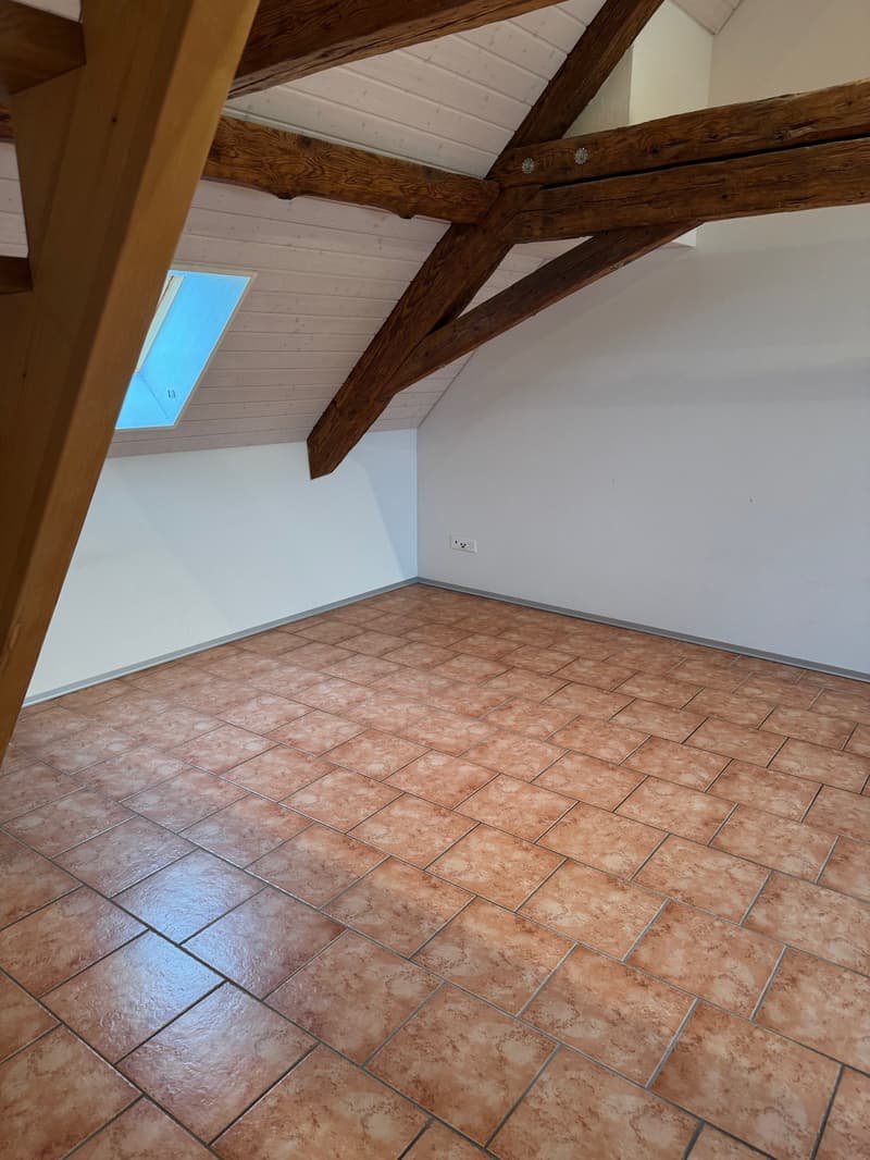 empty room, wooden beams, tiled floor, white walls, small window