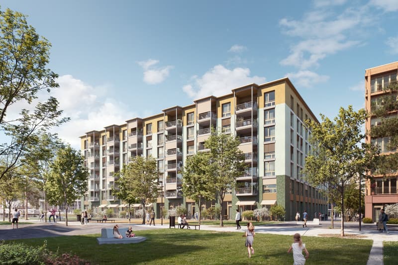 Multi-story apartment building with balconies, surrounded by green landscaping and a public plaza with people walking and relaxing on the grass.