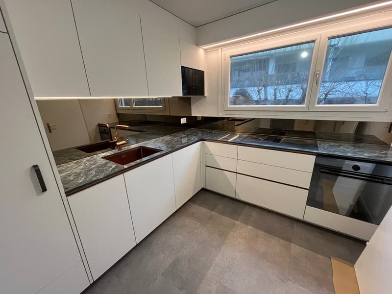 kitchen with granite countertops, modern appliances, large windows