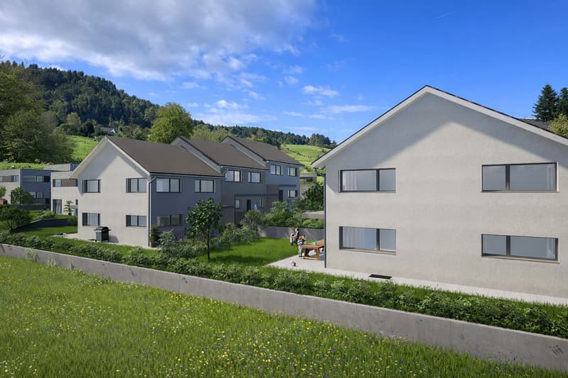 Apartment complex, surrounded by greenery, multiple houses, lawn, mountains in the background