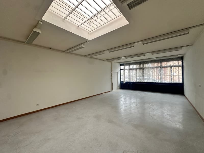 white walls, white concrete floor, glass windows with curtains, glass door with curtains, skylight, lamps