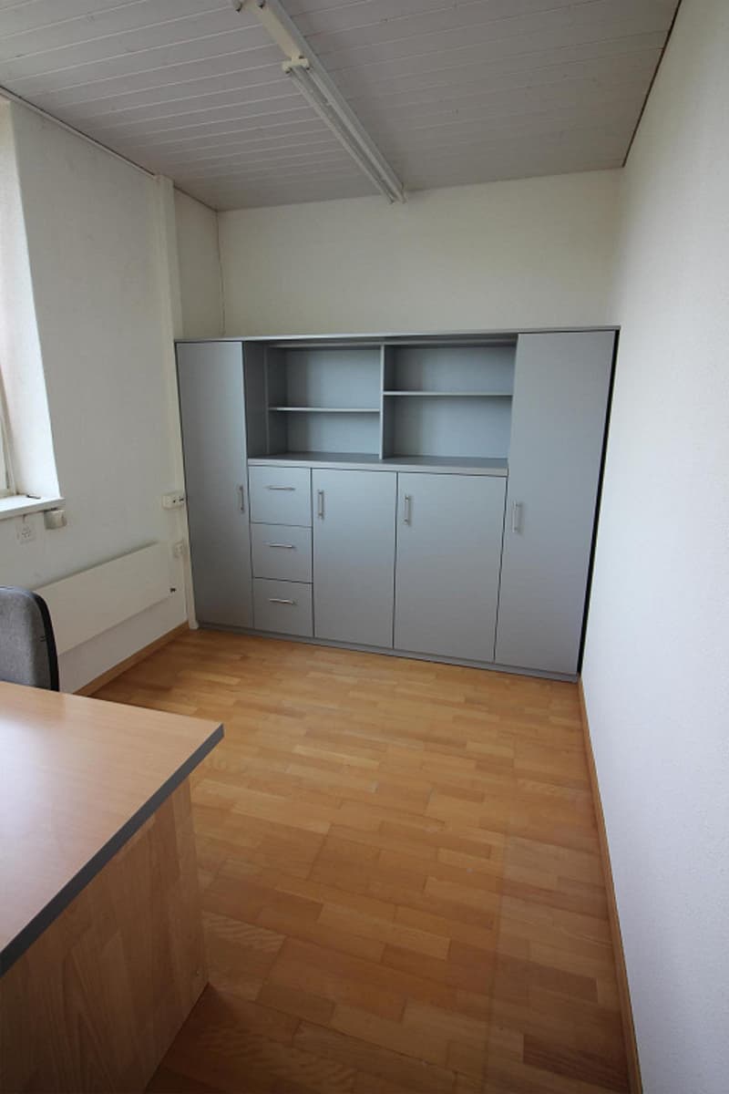 Empty room, gray cabinets, wooden floor, desk