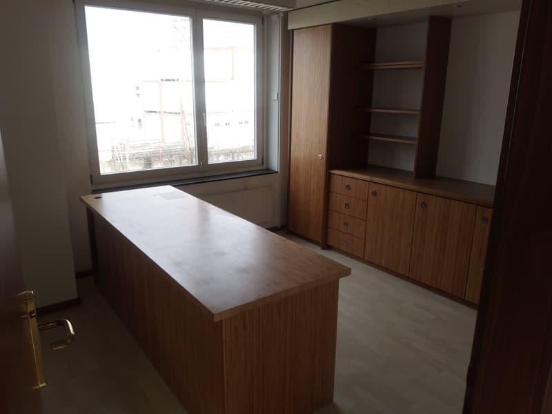 empty room, large window, wooden desk, wooden cabinets, wooden floor