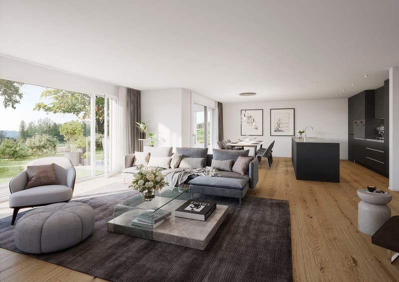 Spacious open-plan living room with large windows overlooking a garden, hardwood flooring, grey sectional sofa, glass coffee table, and a modern kitchen area with black cabinets