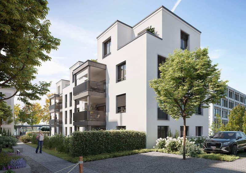 Modern white apartment building with balconies, landscaped garden, paved walkway, and a car parked in front.
