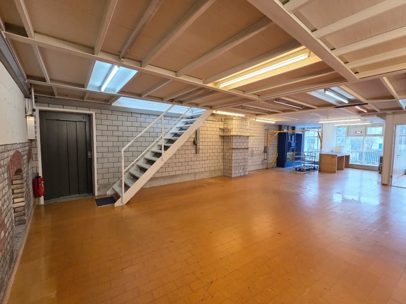 empty room, tiled floor, white brick wall, white railing, staircase, metal cart, fire extinguisher, windows