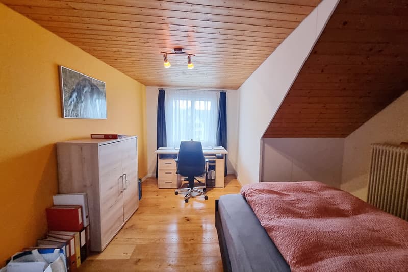Bedroom with desk, chair, wardrobe, bed, radiator, books, photo frame, lamp, window with curtains
