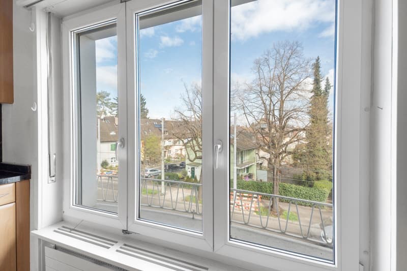 large window with view of street and trees