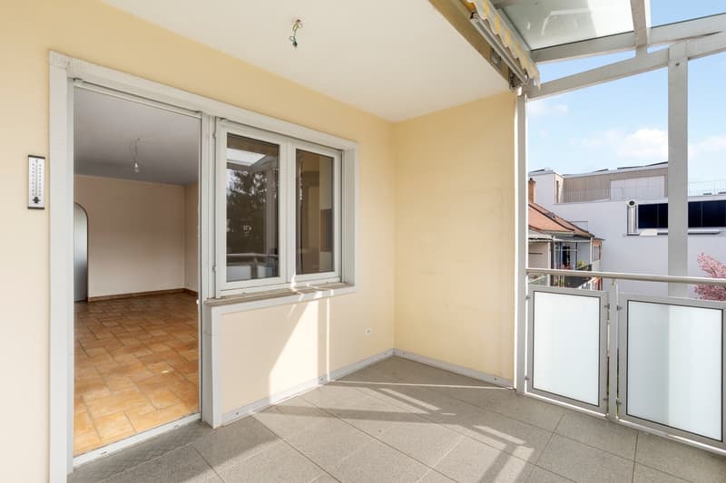 empty room with balcony, tiled floor, glass doors, windows, yellow walls