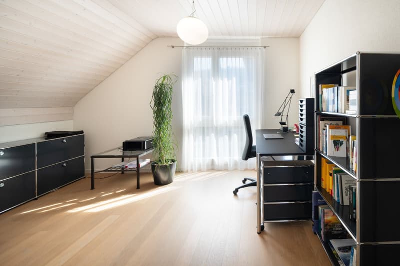 wooden floor, white walls, desk, chair, bookshelf, plant, lamp, window with curtains