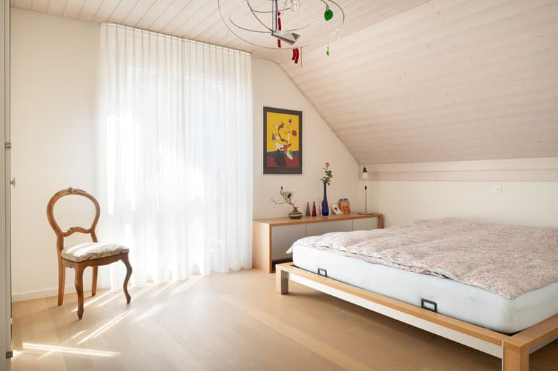 wooden floor, bed, chair, nightstand, painting, white curtains