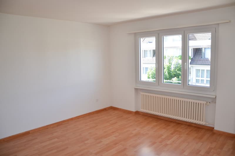 empty room, white walls, wooden floor, white radiator, windows
