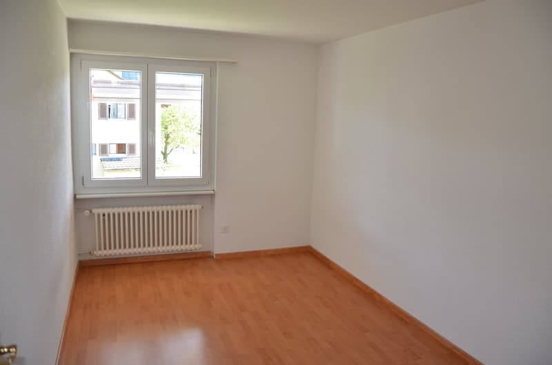 empty room, white walls, wooden floor, window, radiator