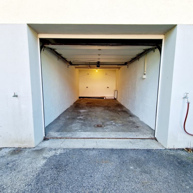 empty, concrete floor, white walls, ceiling light, water tap