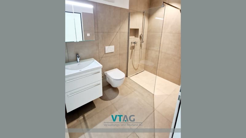 Bathroom with a toilet, sink, and shower
