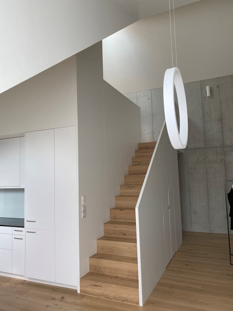 modern interior, white walls, wooden stairs, white cabinets, wooden floor