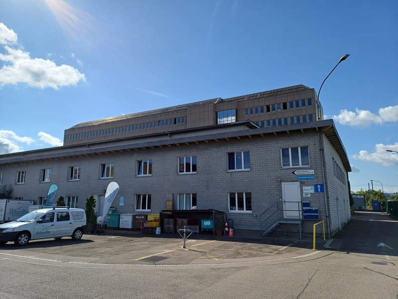 commercial building with a parking lot in front of it