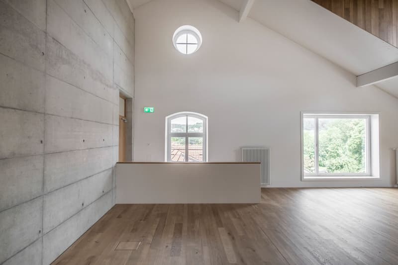 empty room, wooden floor, white walls, concrete wall, windows, radiator