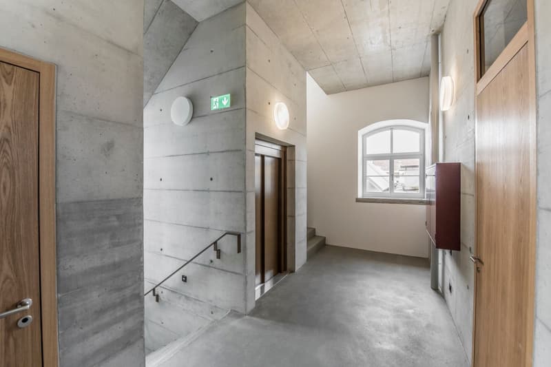 concrete walls, wooden floors, handrail, window, door