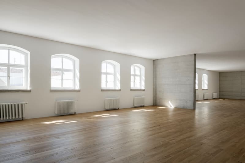 wide room, white walls, white ceiling, hardwood floors, multiple windows