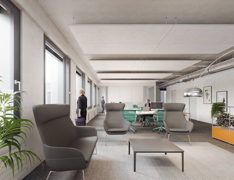 Modern office space, gray furniture, large windows, white walls, central desk with laptops, carpet flooring, plants, hanging lamp