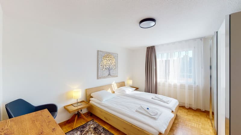 single bed, white linen, bedside tables, lamps, rug, window with curtains