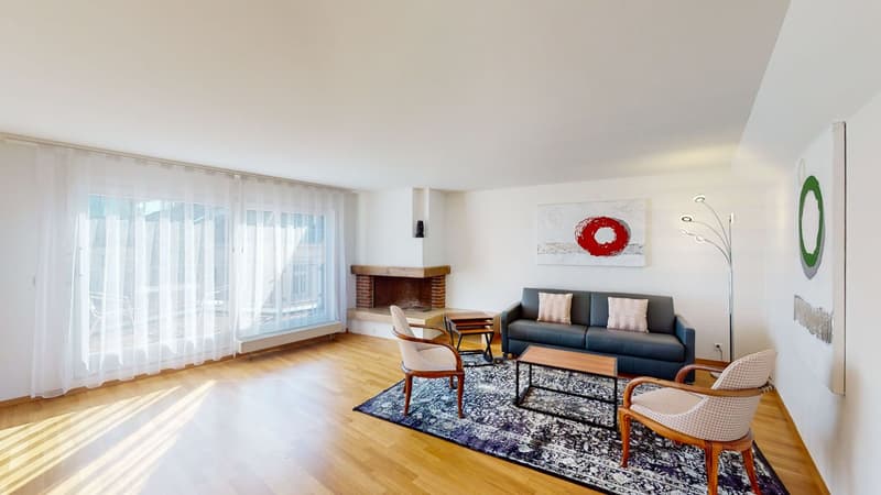 blue couch, wooden coffee table, two chairs, fireplace, large window, area rug