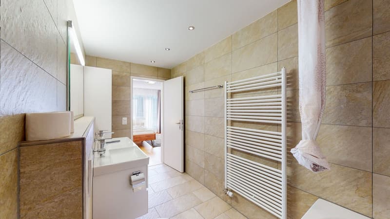 Single sink, modern design, white tiled wall, large mirror, towel dryer