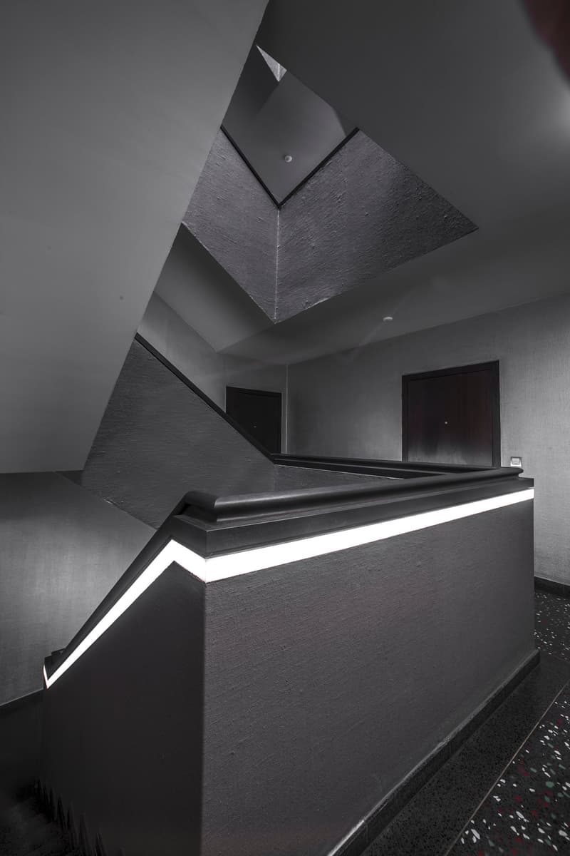 concrete raised ground floor, dark interior, metal railing, LED lighting
