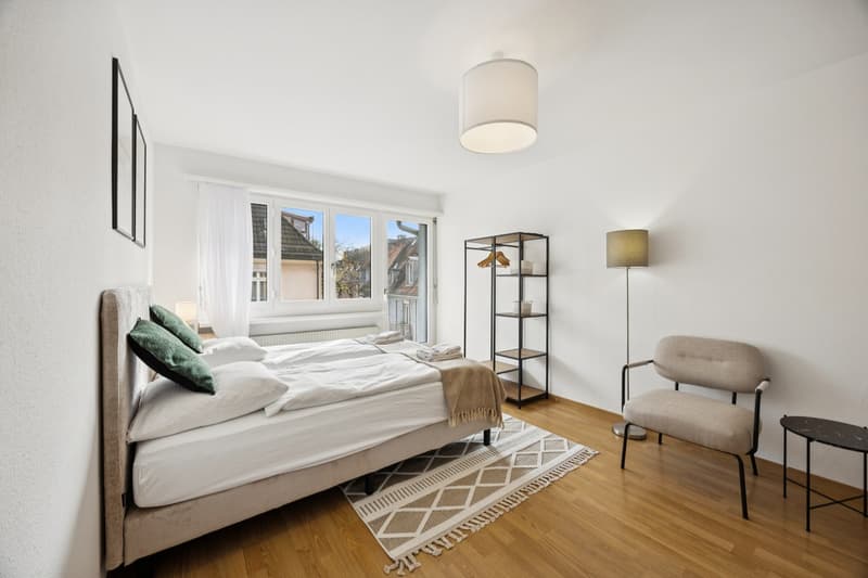 bed, bedside table, chair, lamp, shelf, carpet, radiator, windows with view