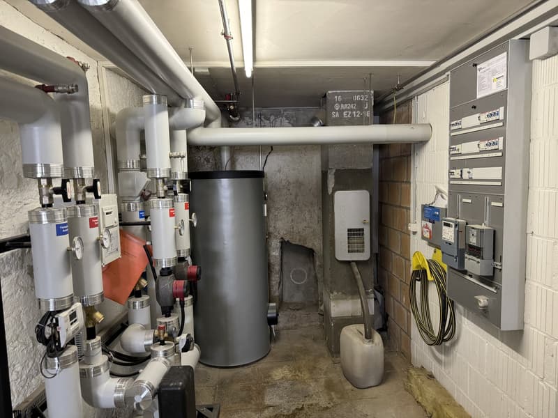 Large water heater, multiple pipes, electrical components, maintenance equipment
