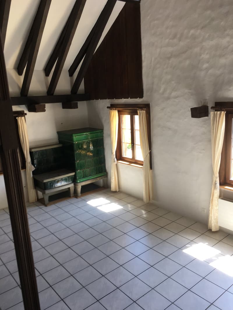 Empty room, wooden ceiling, white tiled floor, green cabinet, two windows