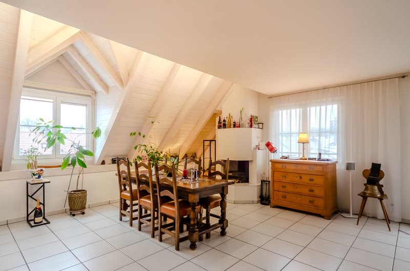dining room, 6 wooden chairs, large window, wooden table, wooden fireplace, wooden chest, indoor plants, wooden floor