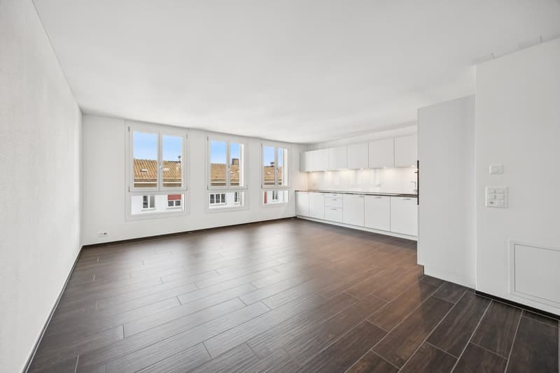 Empty room, wooden floor, large windows, balcony, white cabinets, modern kitchen