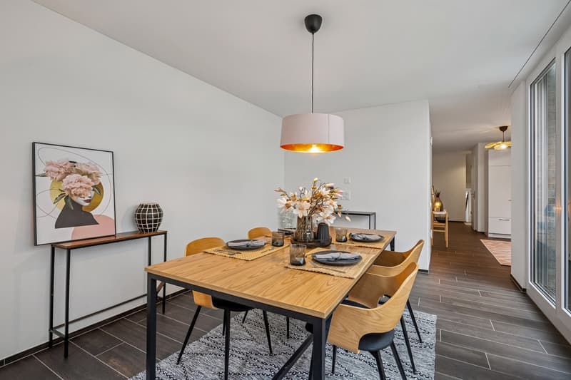Wooden table, metal chairs, glass doors, artwork, flowers, carpet, console table