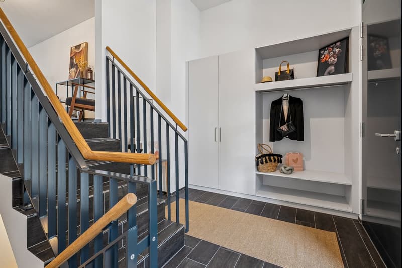 entrance, wooden and metal stairs, wooden handrail, closet, shelf, basket, handbag, hat, bag, and painting