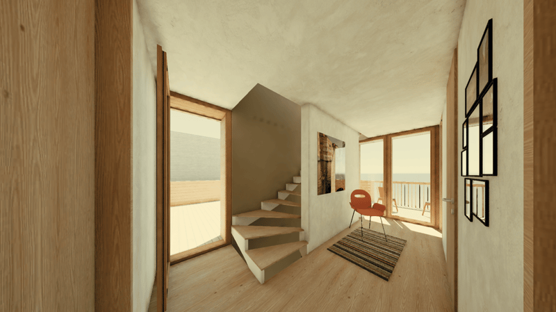 Spacious open-plan living area with wooden floors, white walls, and large windows providing a view of the balcony. The room features a staircase leading to an upper level, a red chair, and a striped rug on the floor.