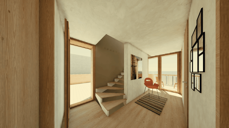 Spacious open-plan living area with wooden floors, white walls, and large windows providing a view of the balcony. The room features a staircase leading to an upper level, a red chair, and a striped rug on the floor.