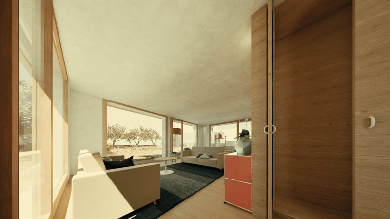 Spacious living room with large windows overlooking a scenic outdoor view, hardwood floors, modern furniture including a sofa and coffee table, and a kitchen area with cabinets and appliances visible in the background.