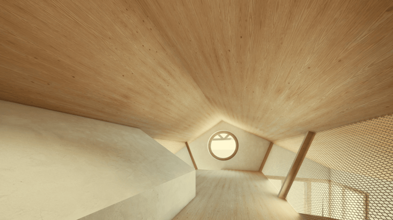 The image shows the interior of a wooden structure with a slanted ceiling and a circular window. The walls and ceiling are made of light-colored wood, creating a warm and cozy atmosphere. The space appears to be an attic or loft-like area, with a raised p
