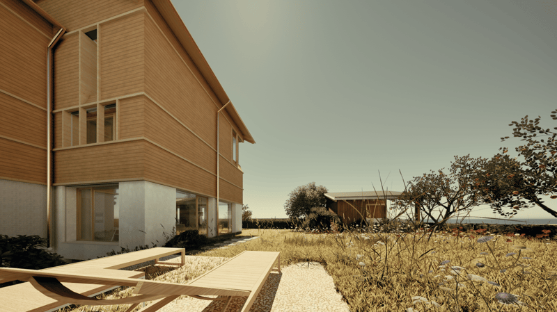 Two-story wooden house with large windows, wooden deck, and surrounded by natural landscape with trees and vegetation