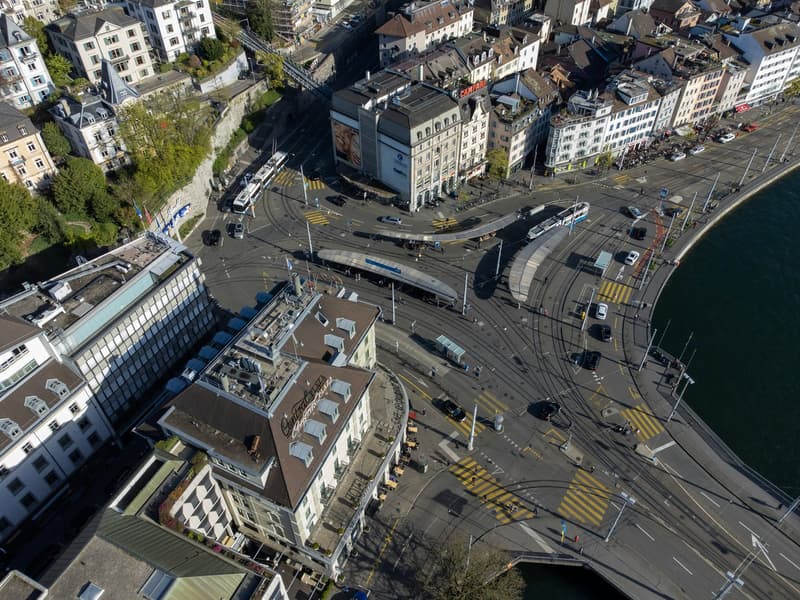aerial view, central location, multi-story building, urban environment, road intersection, waterfront property, pedestrian pathways, multiple buildings surrounding