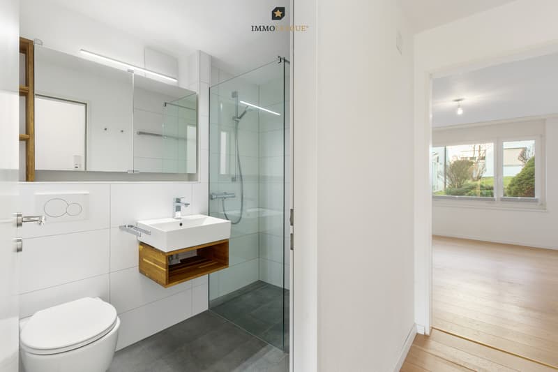 Das Badezimmer nebenan überzeugt mit schönen Materialien und zeitlosem Design.