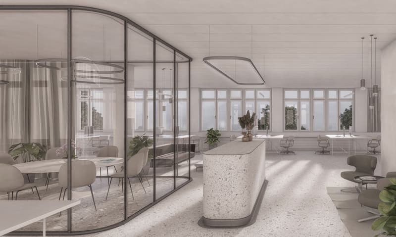 Large open office space with floor-to-ceiling windows, providing a view of the outdoors. The space features a reception desk made of terrazzo material, modern lighting fixtures, and a mix of seating areas and workstations.