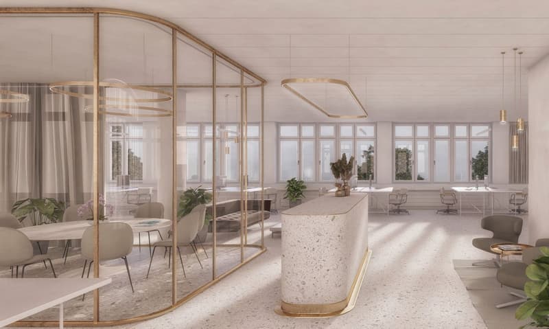 Large open-plan office space with floor-to-ceiling windows, gold-framed glass partitions, terrazzo-style countertop, modern furniture, and pendant lighting fixtures.