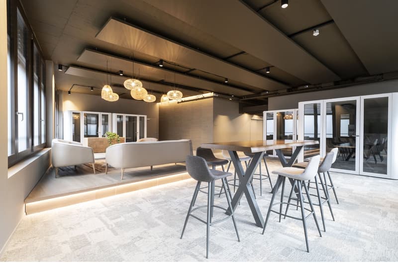 Sleek modern design, large windows, glass doors, wood table, modern chairs, white furniture, contemporary lighting
