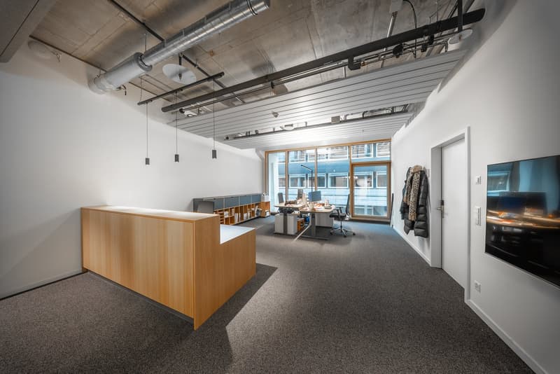 empty office space, large desk, reception desk, large windows, carpeted floor