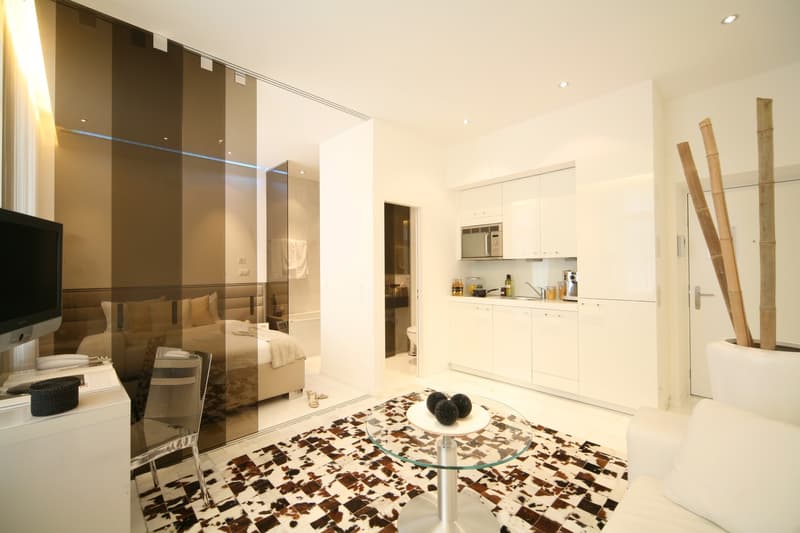 white furniture, modern style, flat screen tv, glass top table, rug, glass wall